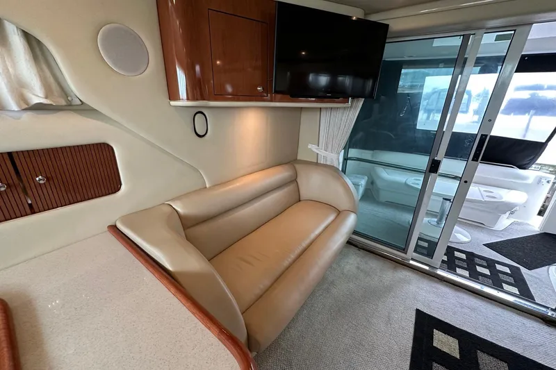 Slide: The Image of Interior of 2002 Sea Ray 400 Sedan Bridge with leather sofa and mounted TV. - 21