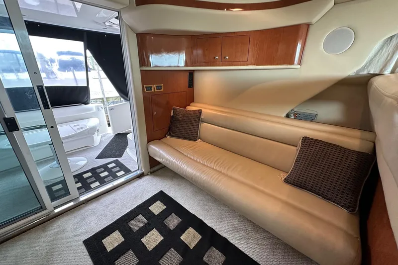 Slide: The Image of Interior of 2002 Sea Ray 400 Sedan Bridge with leather seating and modern decor. - 24