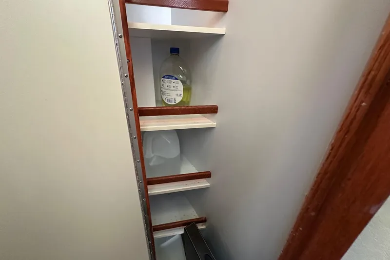 Slide: The Image of Storage shelves inside a 2002 Sea Ray 400 Sedan Bridge boat. - 25