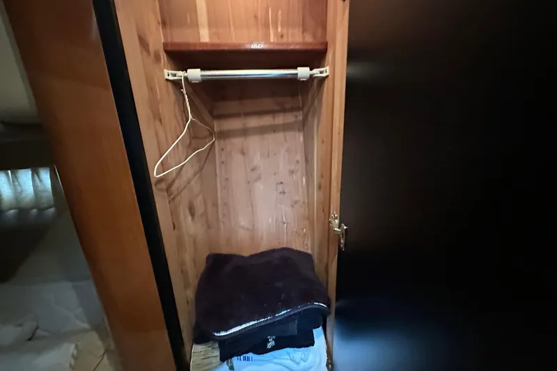 Slide: The Image of Wooden closet interior on a 2002 Sea Ray 400 Sedan Bridge yacht. - 29