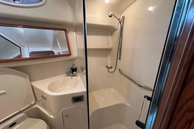 Slide: The Image of Bathroom interior of 2002 Sea Ray 400 Sedan Bridge yacht, featuring sink and shower. - 30