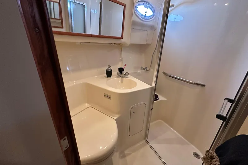 Slide: The Image of Bathroom interior of 2002 Sea Ray 400 Sedan Bridge yacht, featuring sink and shower. - 31