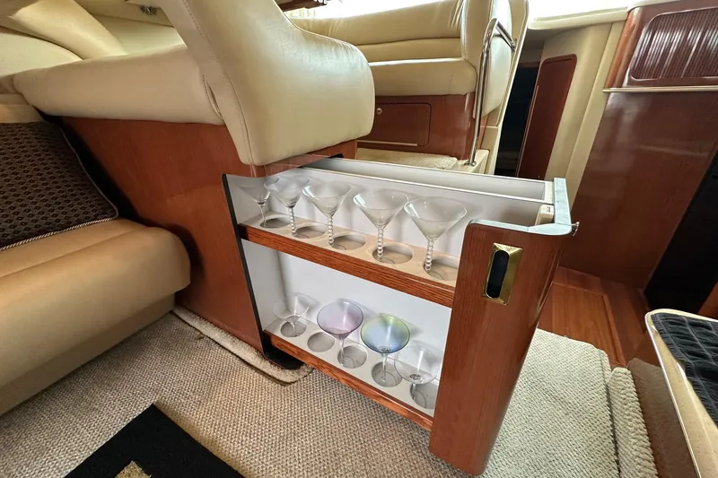 Slide: The Image of Luxurious interior of 2002 Sea Ray 400 Sedan Bridge with built-in glassware storage. - 38