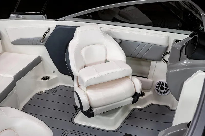 Slide: The Image of Manufacturer Provided Image: 2022 Chaparral 21 Surf boat interior with white captain's chair and sleek design. - 11