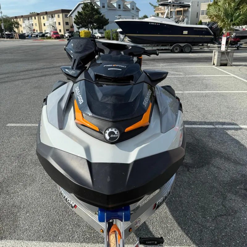 Slide: The Image of 2024 Sea-Doo Fishpro Trophy 170 jet ski parked in a lot, front view. - 3