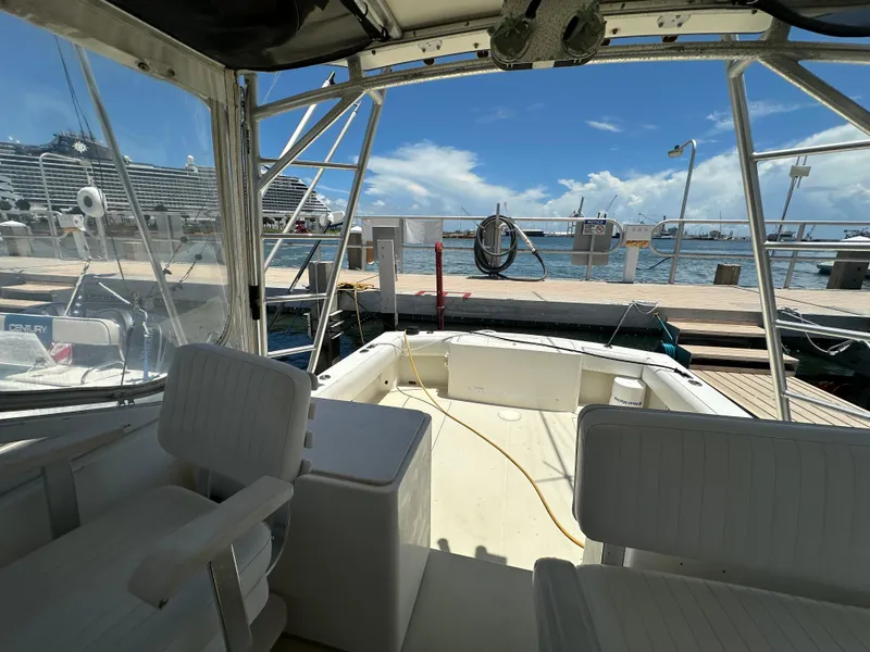Slide: The Image of 2003 Carolina Classic 28 boat interior at dock, with ocean and cruise ship in background. - 15