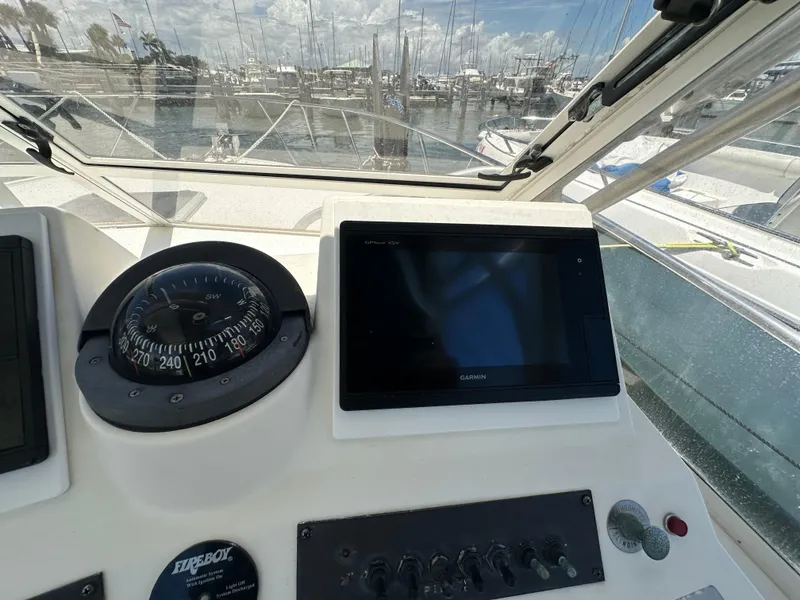 Slide: The Image of 2003 Carolina Classic 28 boat dashboard with compass and Garmin GPS at marina. - 20