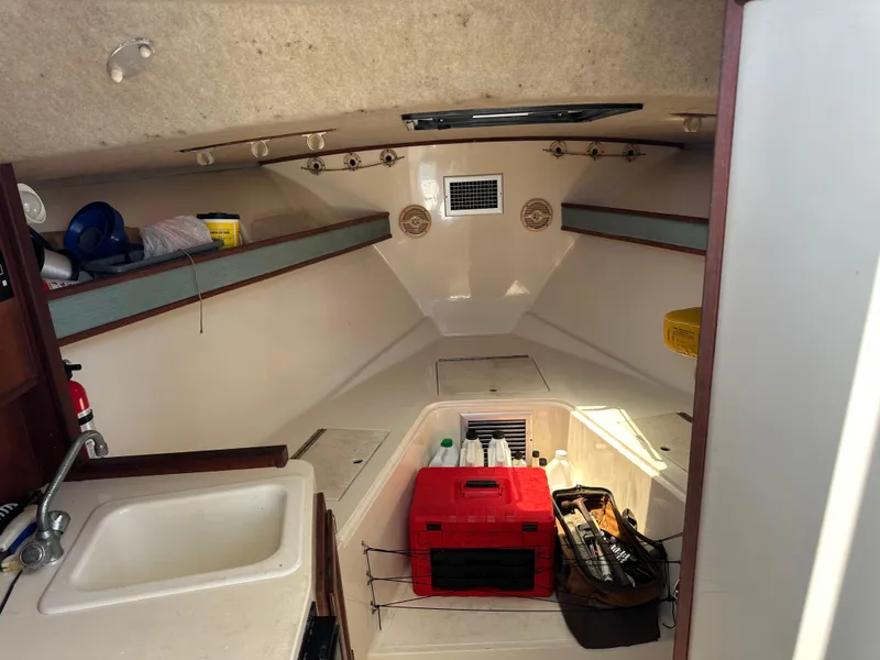 Slide: The Image of Interior of 2003 Carolina Classic 28 boat with storage and sink. - 21