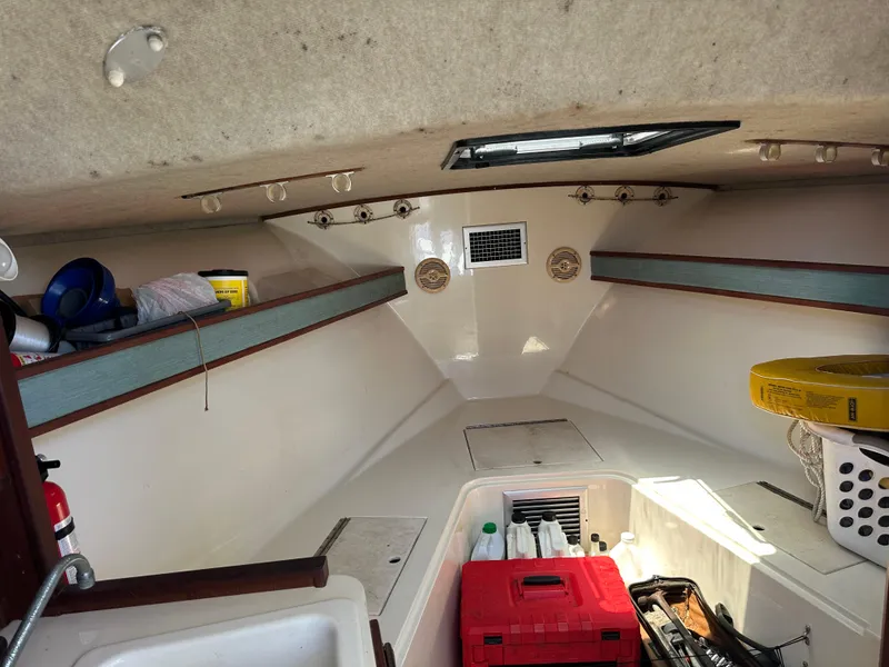 Slide: The Image of Interior of a 2003 Carolina Classic 28 boat with storage and supplies. - 22