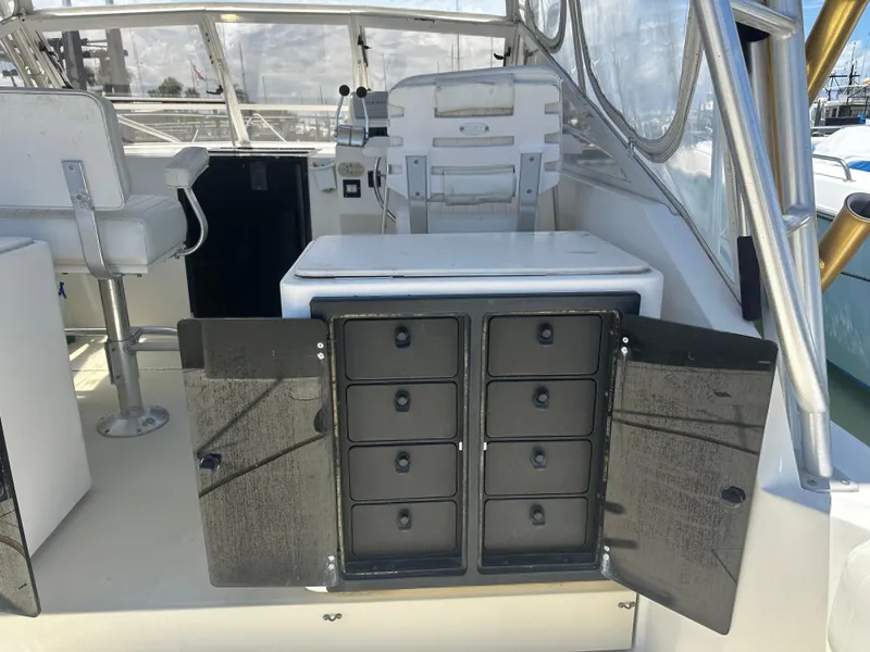 Slide: The Image of 2003 Carolina Classic 28 boat interior with open storage compartments and seating. - 27