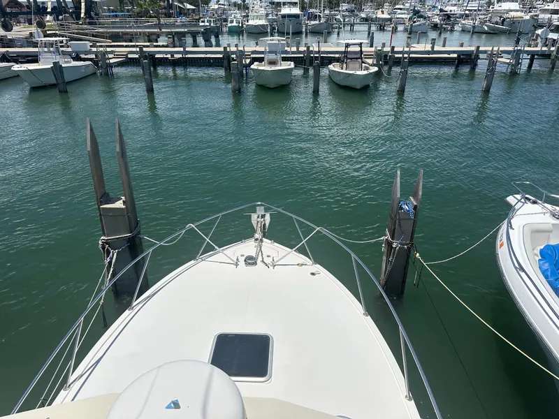 Slide: The Image of 2003 Carolina Classic 28 boat docked at a marina with other vessels. - 31