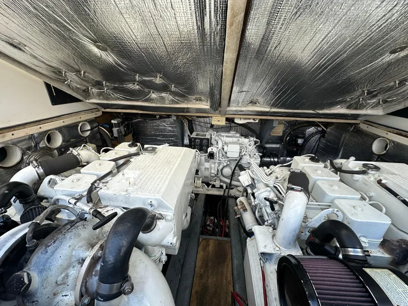 Slide: The Image of Engine room of a 2003 Carolina Classic 28 boat, featuring dual engines and insulated walls. - 32