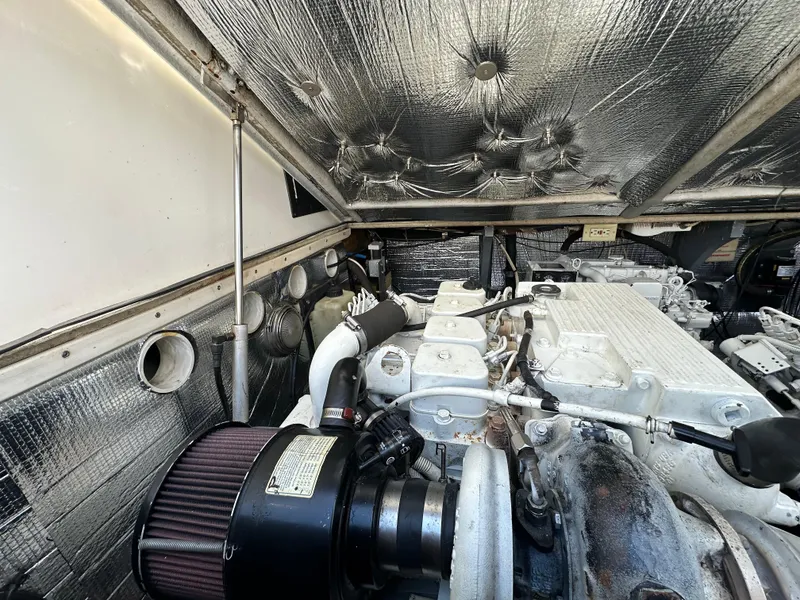 Slide: The Image of Engine compartment of a 2003 Carolina Classic 28 boat, showcasing detailed mechanical components. - 34