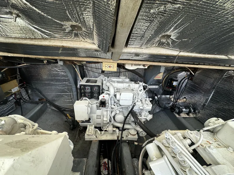 Slide: The Image of Engine room of a 2003 Carolina Classic 28 boat, featuring mechanical components and wiring. - 35