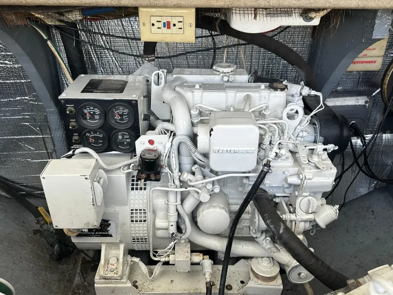Slide: The Image of Engine compartment of a 2003 Carolina Classic 28 boat, featuring a Westerbeke generator. - 36