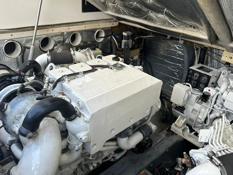 Slide: The Image of Engine compartment of a 2003 Carolina Classic 28 boat, showcasing detailed mechanical components. - 38
