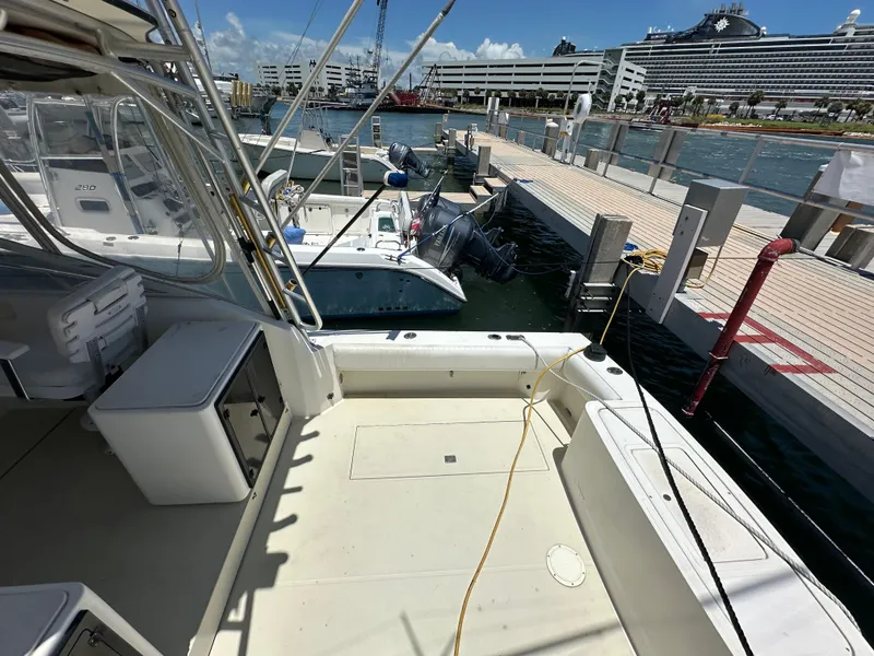 Slide: The Image of 2003 Carolina Classic 28 boat docked at marina with cruise ship in background. - 5