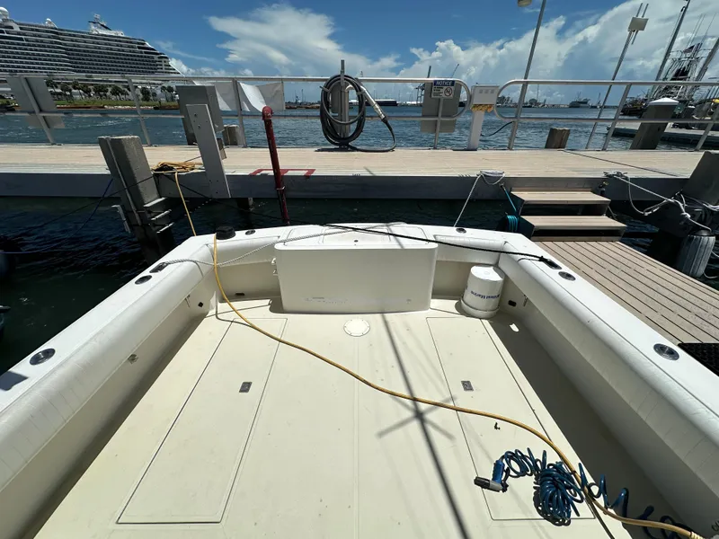 Slide: The Image of 2003 Carolina Classic 28 boat docked at marina with cruise ship in background. - 7