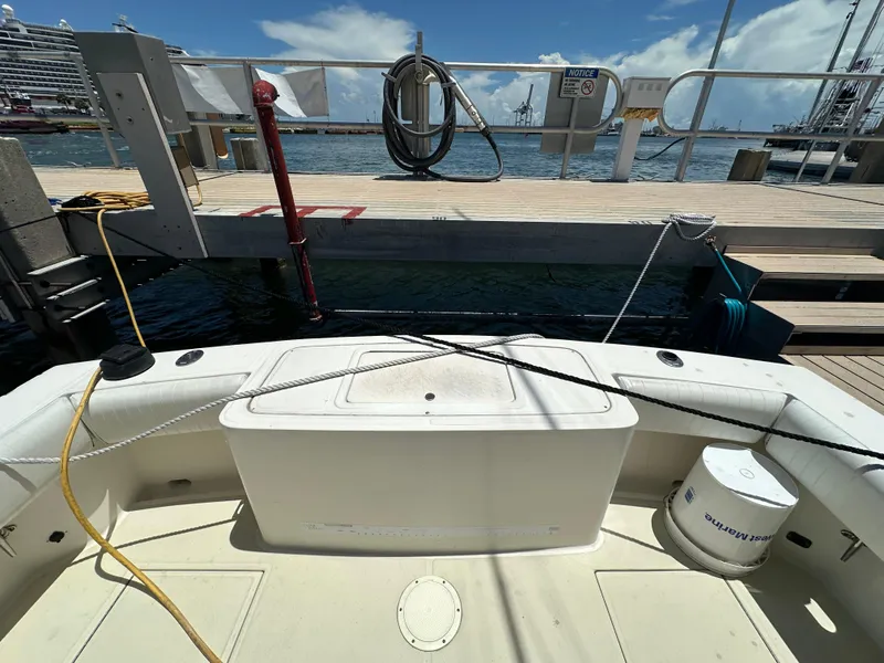 Slide: The Image of 2003 Carolina Classic 28 boat docked at marina with clear sky and water view. - 8