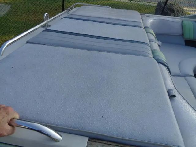 Slide: The Image of 1987 Sea Ray S23 boat with cushioned seating and metal railing. - 10