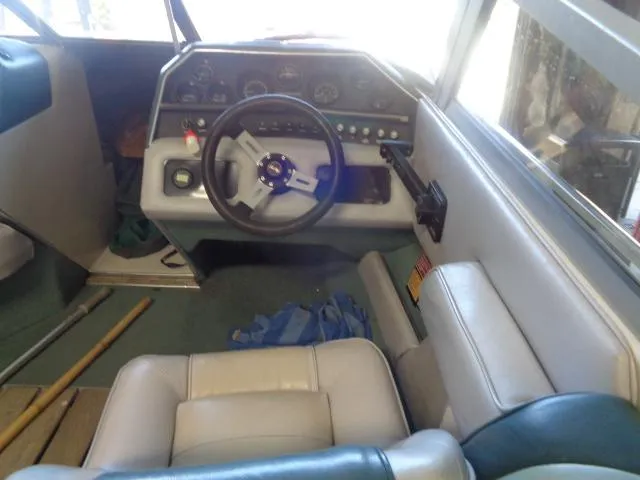 Slide: The Image of Interior of a 1987 Sea Ray S23 boat showing steering wheel and dashboard controls. - 2