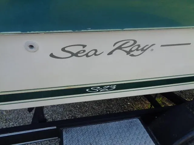 Slide: The Image of 1987 Sea Ray S23 boat on trailer, featuring classic logo and design. - 7