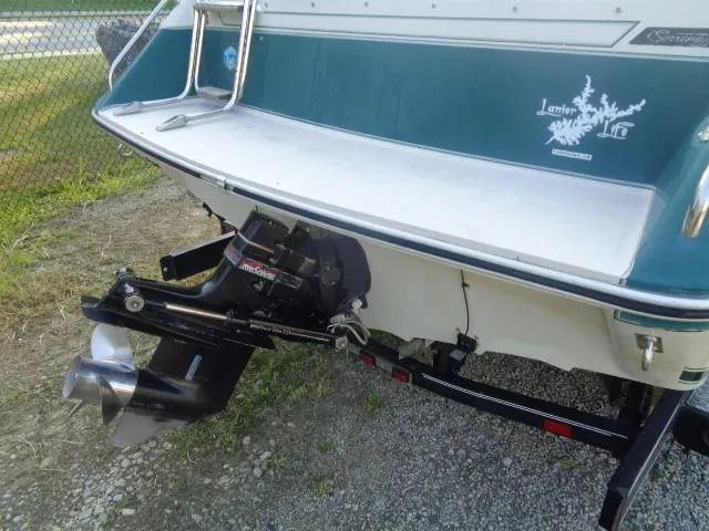 Slide: The Image of 1987 Sea Ray S23 boat stern with outboard motor and trailer. - 8