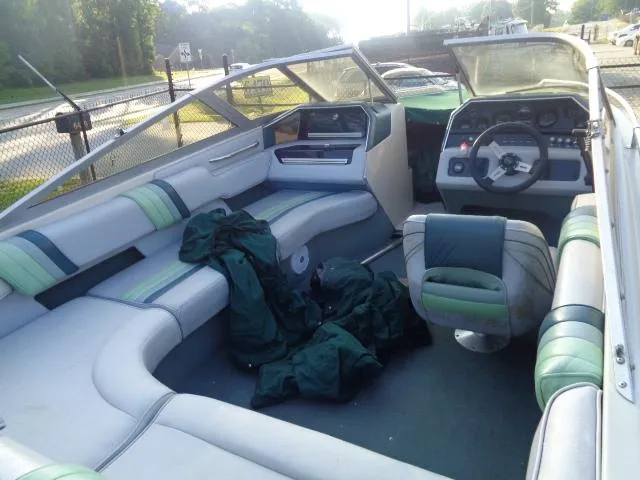Slide: The Image of 1987 Sea Ray S23 boat interior with green and white seating, steering wheel, and dashboard. - 9