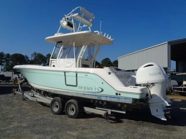 The Image of 2019 Robalo R272 Center Console boat on trailer, parked outdoors. - 0