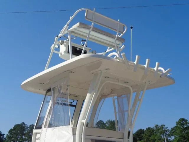 Slide: The Image of 2019 Robalo R272 Center Console boat with elevated helm station against clear blue sky. - 10