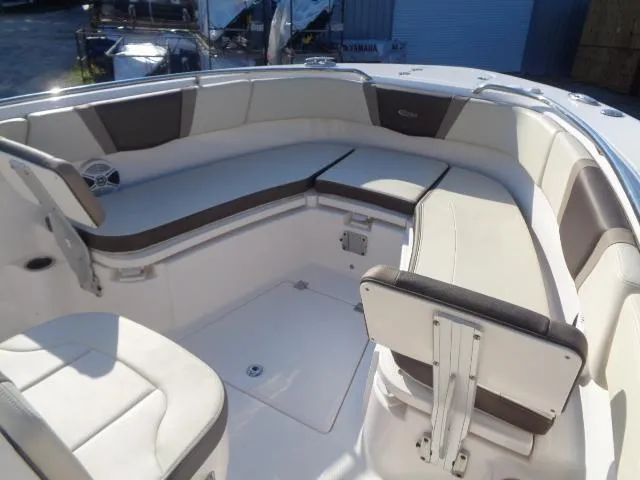 Slide: The Image of 2019 Robalo R272 Center Console boat interior with cushioned seating and storage. - 14