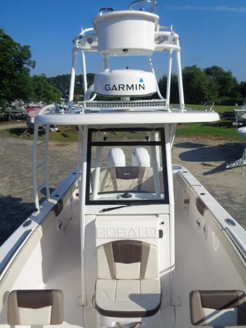 Slide: The Image of 2019 Robalo R272 Center Console boat with Garmin radar, docked outdoors. - 15