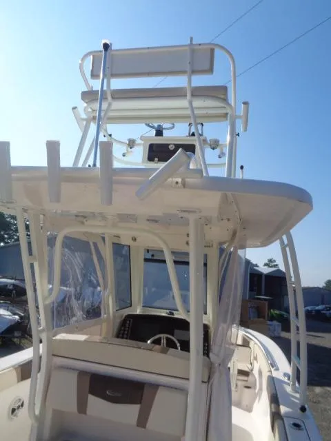 Slide: The Image of 2019 Robalo R272 Center Console boat with dual helm seating and fishing rod holders. - 16