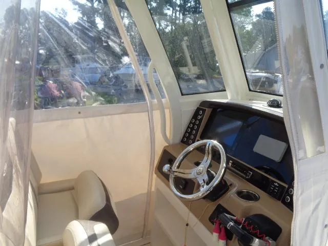 Slide: The Image of 2019 Robalo R272 Center Console boat interior with steering wheel and navigation system. - 19