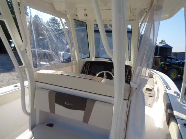 Slide: The Image of 2019 Robalo R272 Center Console boat interior with steering console and seating. - 20