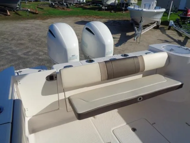 Slide: The Image of 2019 Robalo R272 Center Console boat with dual engines and seating area. - 23
