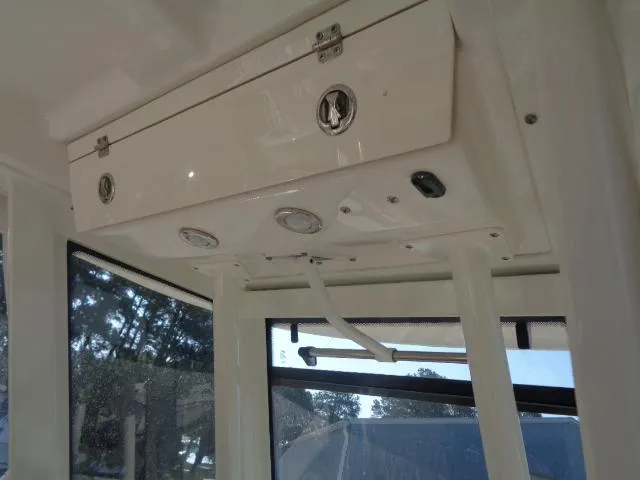 Slide: The Image of 2019 Robalo R272 Center Console interior with storage compartment and windows. - 29