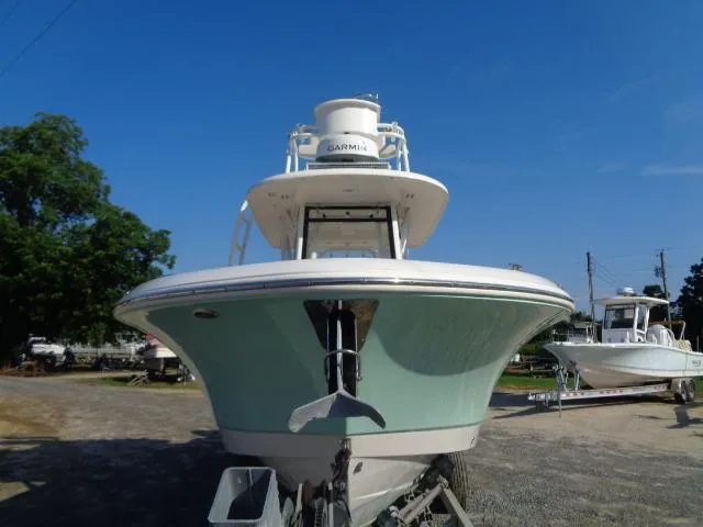 Slide: The Image of 2019 Robalo R272 Center Console boat on trailer, front view, clear blue sky. - 3