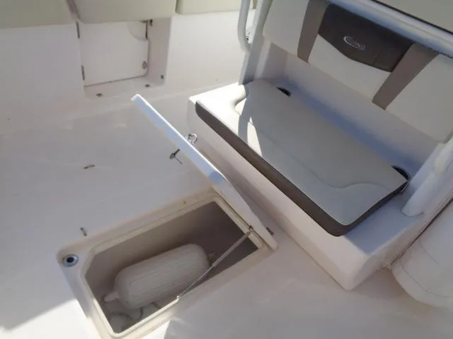 Slide: The Image of 2019 Robalo R272 Center Console boat interior with storage compartment open. - 30