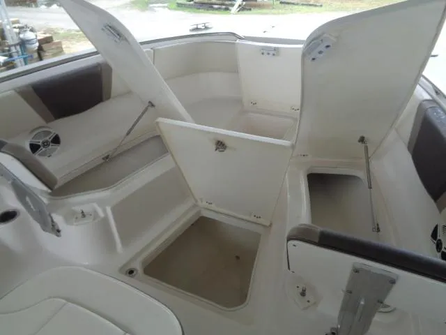 Slide: The Image of 2019 Robalo R272 Center Console boat with open storage compartments. - 33