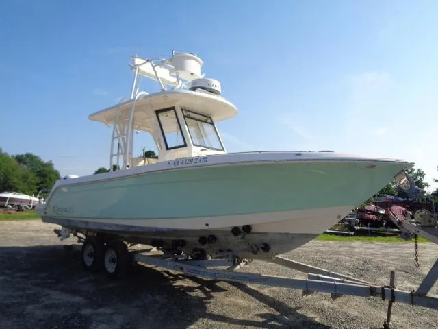Slide: The Image of 2019 Robalo R272 Center Console boat on trailer, light blue hull, sunny day. - 5