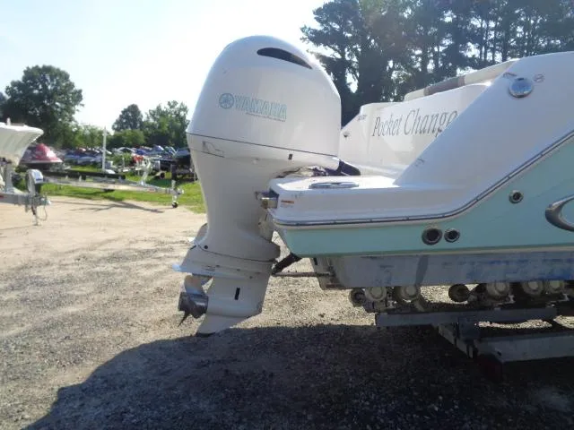 Slide: The Image of 2019 Robalo R272 Center Console boat with Yamaha outboard motor on a trailer. - 7