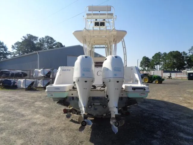 Slide: The Image of 2019 Robalo R272 Center Console boat with dual outboard engines, parked outdoors. - 8