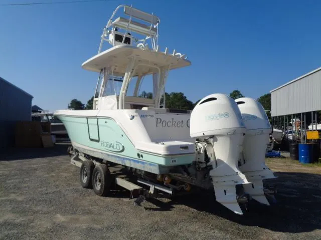 Slide: The Image of 2019 Robalo R272 Center Console boat on trailer, dual engines, outdoor setting. - 9