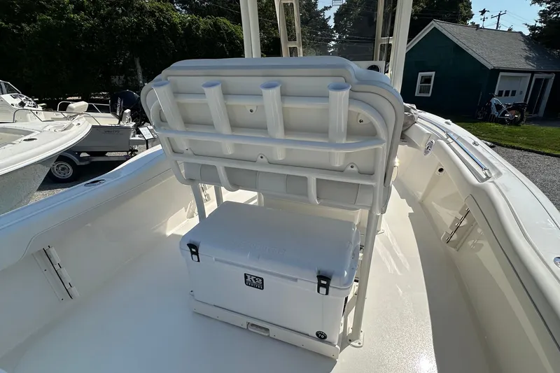 Slide: The Image of 2026 Key West 219 FS boat interior with seating and cooler storage. - 11