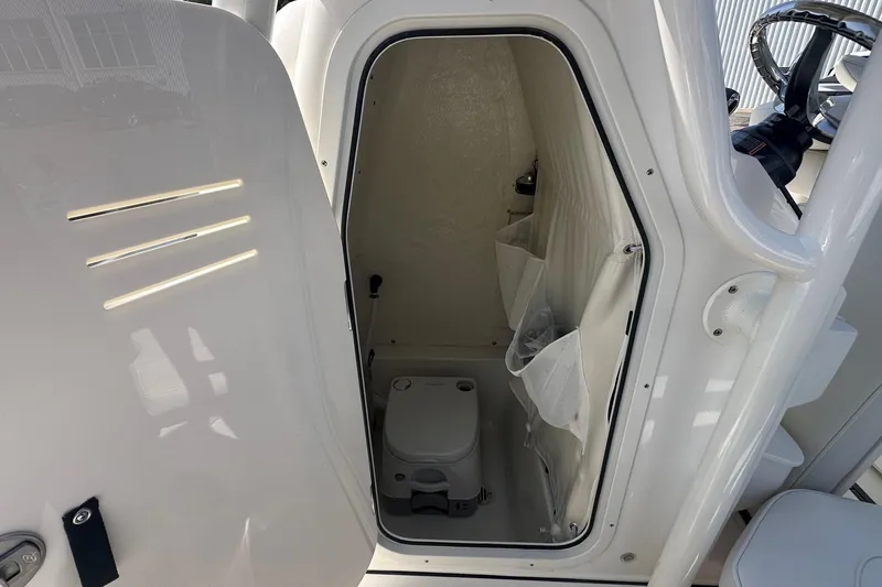 Slide: The Image of 2026 Key West 219 FS boat interior with compact marine toilet. - 19