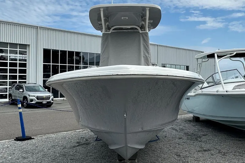 Slide: The Image of 2026 Key West 219 FS boat displayed outdoors near a modern building. - 2