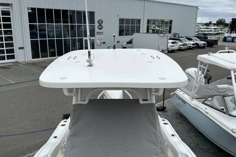 Slide: The Image of 2026 Key West 219 FS boat top view at a marina with parked vehicles. - 22