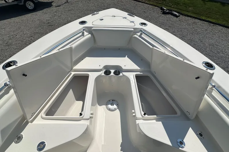 Slide: The Image of 2026 Key West 219 FS boat interior with open storage compartments and cup holders. - 23