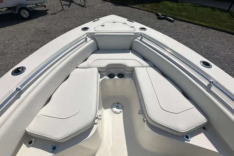 Slide: The Image of 2026 Key West 219 FS boat interior with cushioned seating and cup holders. - 24